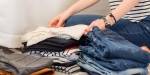 pile of clothes, female arms and hands holding clothes