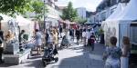 People walking in a pedestrian street in Lillestrøm centre. It is a sunny day.