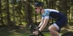 Young man on a road bike in a forest.