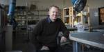 Arild Berg sitting at a table in a workshop