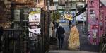 An alley covered in grafitti and street art.