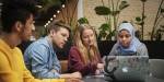 Four students working together at a table.