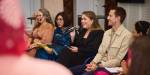 A panel of people of different nationalities discussing