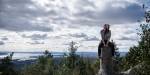 Julia sitting in front of the view over parts of Oslo and the Oslo Fjord.