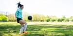 Young woman playing with a soccerball