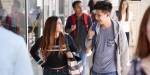 Upper secondary school pupils walking in hall at school