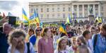Ukrainians gathered in front of the Norwegian Palace, many have Ukrainian flags in celebration of the Ukrainian independence day. The palace is visible in the background.