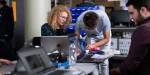Three students at Makerspace working on computers.