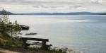 The Oslo Fjord seen from a viewing point on a cliff. Calm water and hills at the distance .