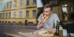 Simen enjoying a slice of the pizza he made. Photo: Benjamin A. Ward