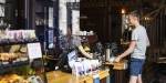 Man buying coffee and something to eat at the cafe counter.