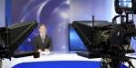 Cameras poiting towards a tv-presenter. Photo by Ivicans.