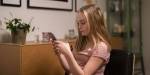 An adolescent girl busy using her phone.