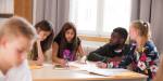 Pupils working in a classroom with a teacher