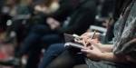 Several journalists takes notes during a press release.