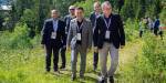 Group photo of members of the core group for Net Zero Future. They are out in the forest, walking on a path. It is summer and sunny.