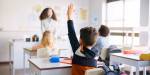 Child raising hand in class
