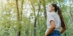 woman with face mask in forest