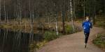 Jogger on a forest path next to Sognsvann lake.