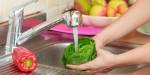 woman washing salad and vegetables