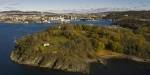 View of Hovedøya in autumn colours and the Oslo skyline.