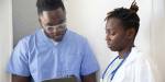 A doctor and a nurse look at a chart.