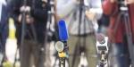 Microphones standing in front of journalists. Photo by Mihajlo Maricic.