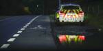 A police car parked by the roadside following a violent incident.