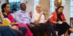 A panel of people of different nationalities discussing
