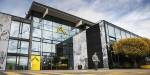 Kjeller Campus building with huge glass facade and yellow OsloMet details.