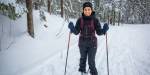 Happy skier in a snowy forest.