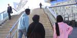 Four youths are heading towards some steps.