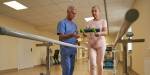 Patient in recovery doing a balance exercise with a physiotherapist.