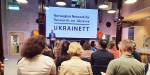 the opening of Ukrainett - Norwegian Network for Research on Ukraine - seen from the back of the room, with audiences backs to camera and Aande Aasland on stage