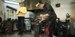 A student welding with sparks flying.