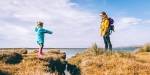 Woman and child outdoor in hiking gear.