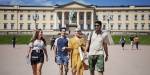 Four young people in front of the royal palace.