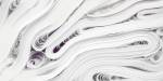Large piles of white fabric lying in layers.