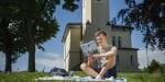 Man reading a book in a park.