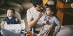 A father gives medicine on a spoon to his child.