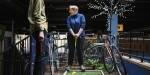 Woman at an indoors miniature golf field.