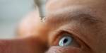 man drops eye drops, moisturizing eye