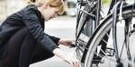 woman dressed in black fixing a bike