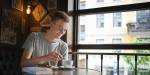 Simen with coffee, a book and a cinnamon bun at a café. Photo: Benjamin A. Ward