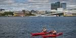 Kayakers paddle around in the Oslofjord with the Norwegian Opera House in the background. Photo: Benjamin A. Ward.