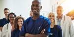 Smiling health care professionals in blue and white uniforms.