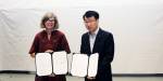 Tanja Storsul and Jame Lee hold up the signed collaboration agreement